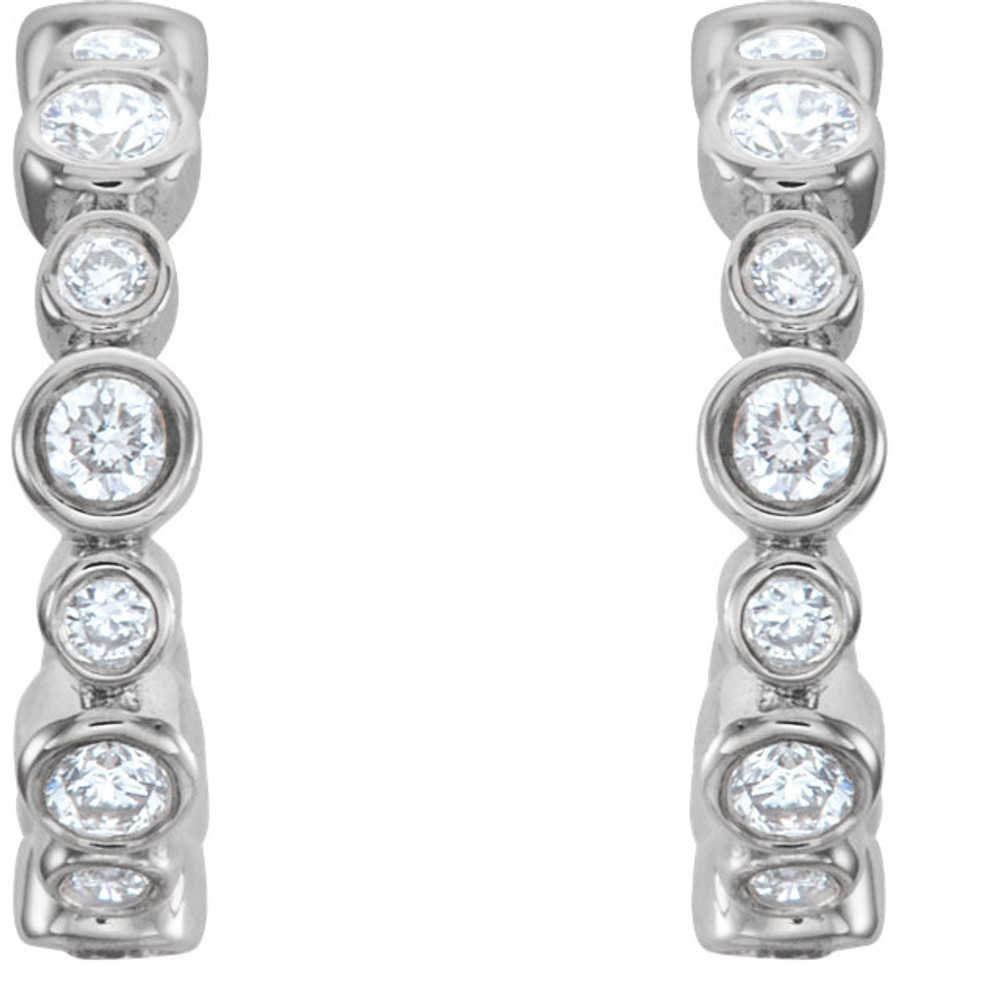 In each 14k White Gold J-Hoop Earring, twelve diamonds are bezel set. Earrings are finished with friction backs for pierced ears. Each earring has roughly .125 carats, for a total diamond weight of 1/4 carats.