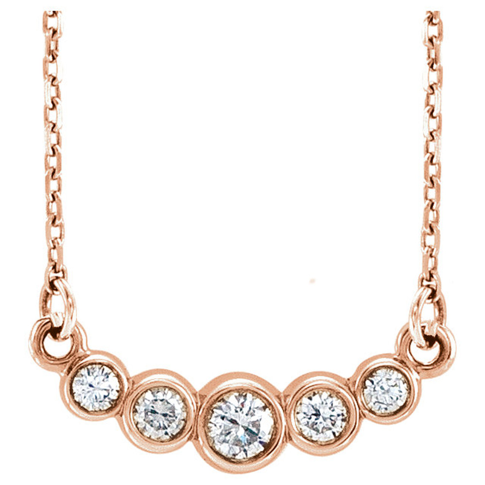 Beautiful 14Kt rose gold graduated bezel set 1/5 ct. tw. diamond necklace hanging from a 16-18" inch chain which is included.