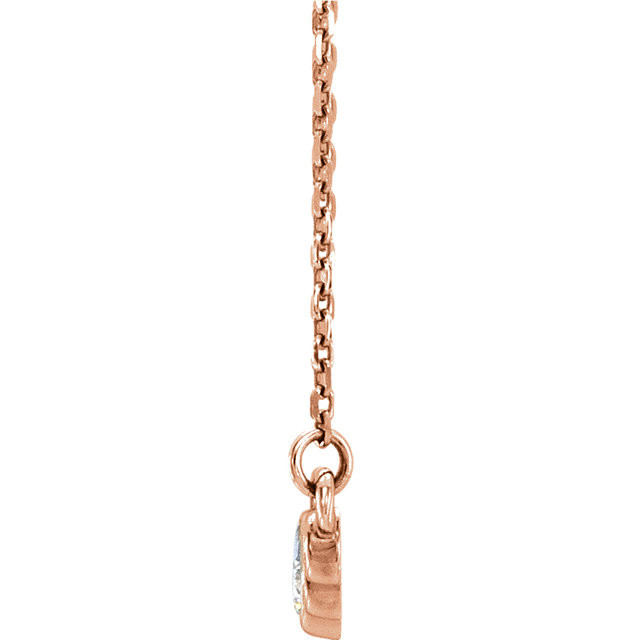 Beautiful 14Kt rose gold graduated bezel set 1/5 ct. tw. diamond necklace hanging from a 16-18" inch chain which is included.