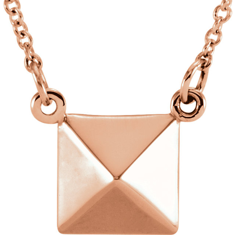 Fashioned in 14K rose gold, the pendant alone is solid and weighs 3.34 grams. It comes with a 14K rose gold sold cable 16.25 inch chain.