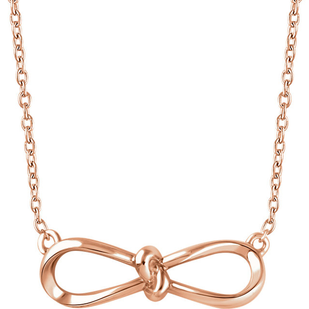 Stunning design is found in this 14Kt rose gold bow pendant hanging from a 14Kt rose gold 18" inch chain. Total weight of the gold is 1.49 grams.