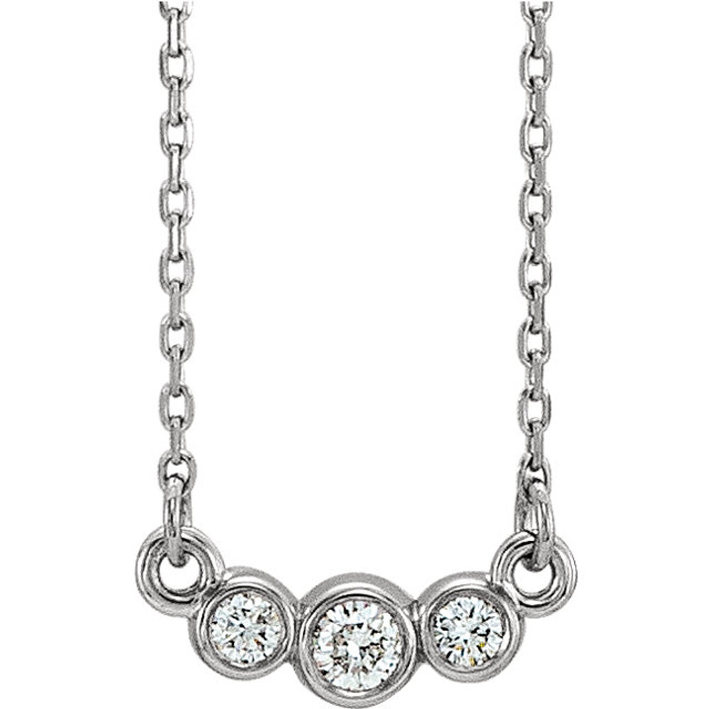 Beautiful 14Kt White gold graduated bezel set 1/8 ct. tw. diamond necklace hanging from a 16-18" inch chain which is included.