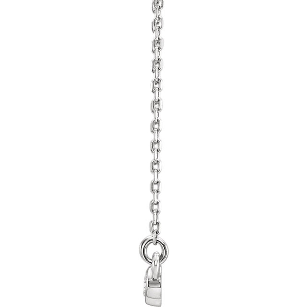 Beautiful platinum graduated bezel set 1/8 ct. tw. diamond necklace hanging from a 16-18" inch chain which is included.
