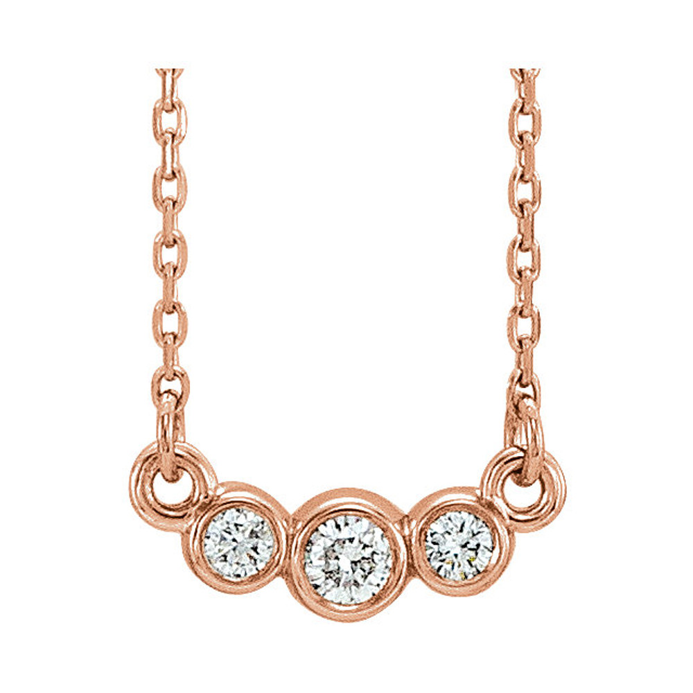 Beautiful 14Kt rose gold graduated bezel set 1/8 ct. tw. diamond necklace hanging from a 16-18" inch chain which is included.