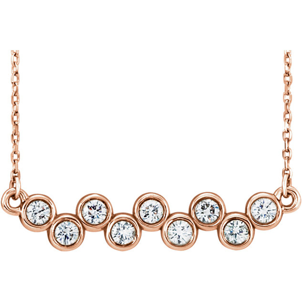 Beautiful 14Kt rose gold graduated bezel set 1/2 ct. tw. diamond necklace hanging from a 16-18" inch chain which is included.