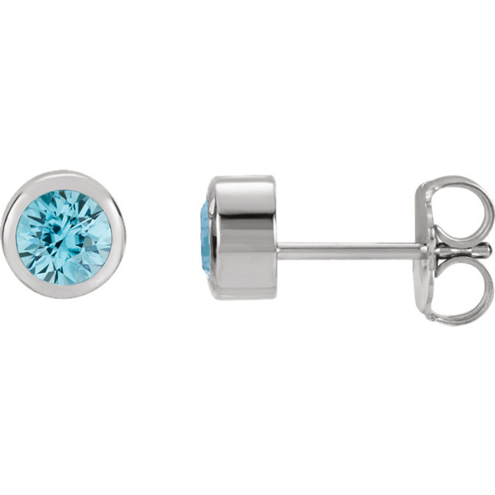 Delightfully colorful, these hand-selected gemstone earrings feature vibrant blue topaz gemstones complemented by 14k white gold round bezel set stud settings.