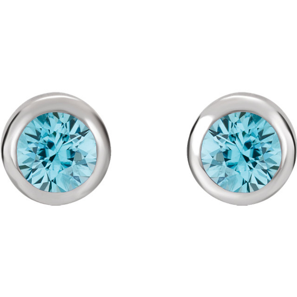 Delightfully colorful, these hand-selected gemstone earrings feature vibrant blue topaz gemstones complemented by 14k white gold round bezel set stud settings.