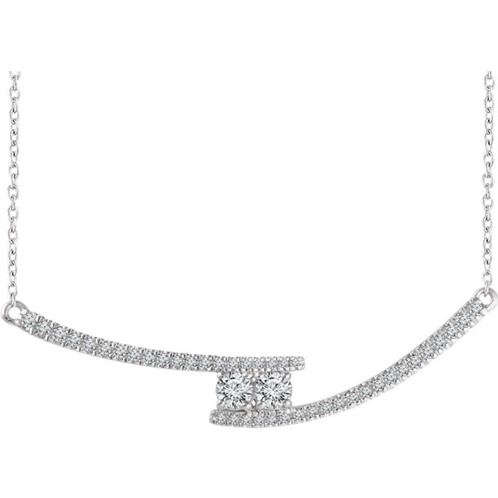 Chic and sparkling, this diamond two stone necklace features round diamonds in 14k white gold, and a matching cable chain. This necklace can be worn at 16 or 18 inches in length.