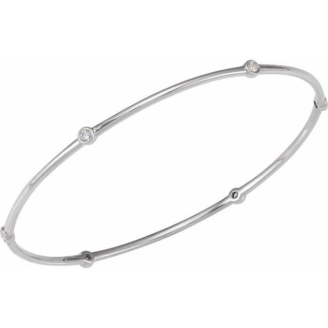Women's bangle bracelet features a round brilliant cut natural diamond. The diamond is bezel set in solid 14k white gold.