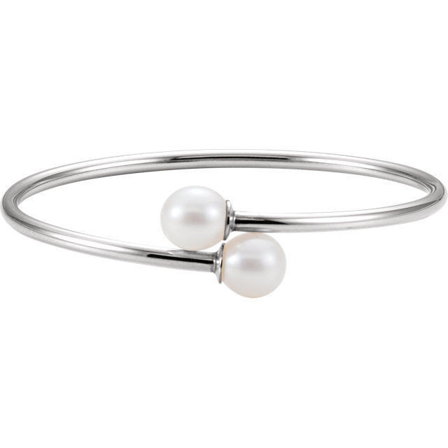 This beautiful bangle bracelet features one 9.5-10mm round Freshwater Cultured Pearl at each end. This flexible bracelet is made in Sterling Silver and measures 7 inches long with a 20mm width.