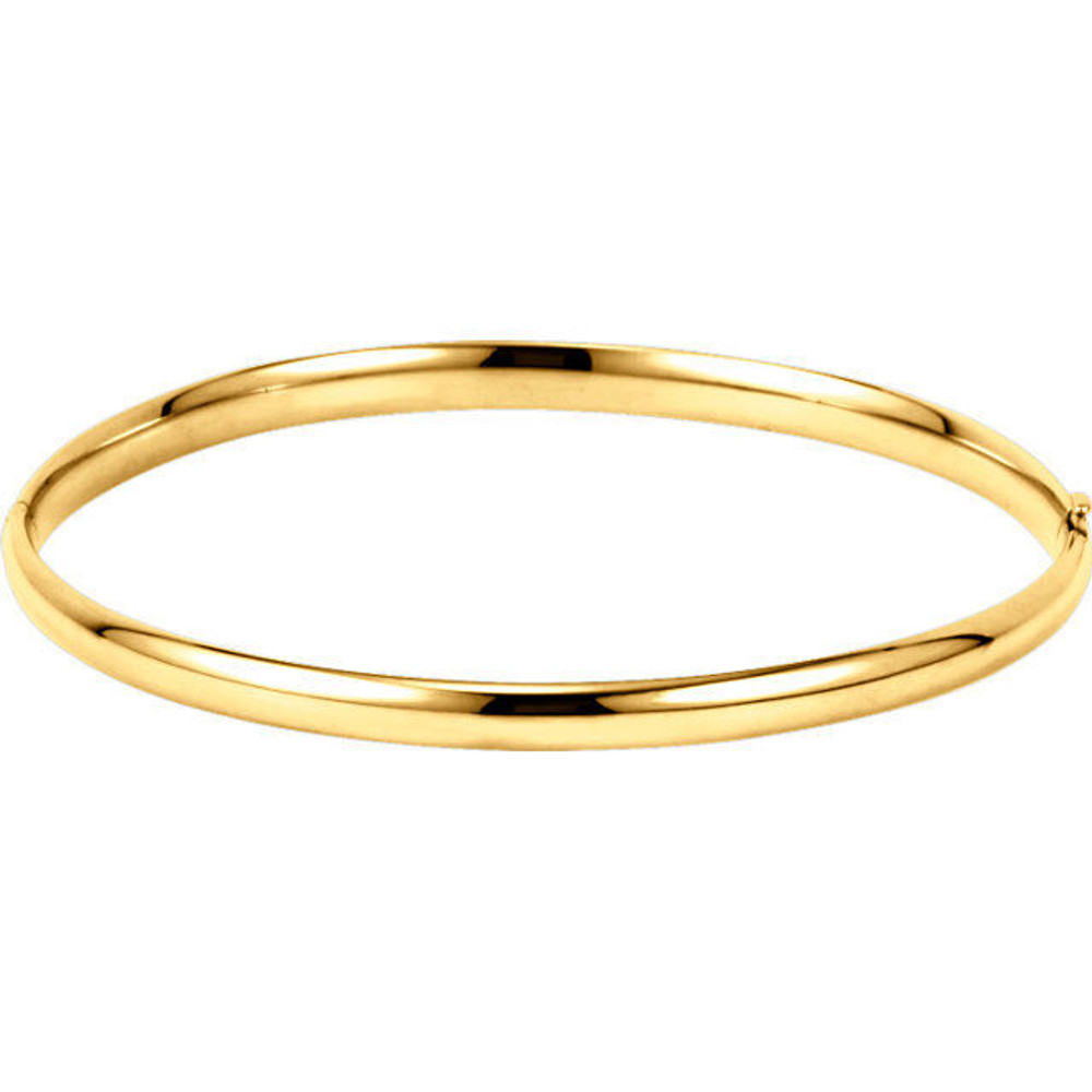 Crafted in brightly polished 14k yellow gold, this hollow, hinged bracelet is lightweight yet looks substantial. A statement piece on its own, stack with other bracelets for an on-trend look.