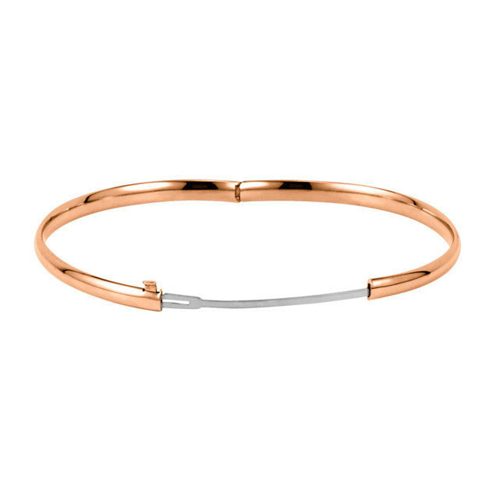 Crafted in brightly polished 14k rose gold, this hollow, hinged bracelet is lightweight yet looks substantial. A statement piece on its own, stack with other bracelets for an on-trend look.