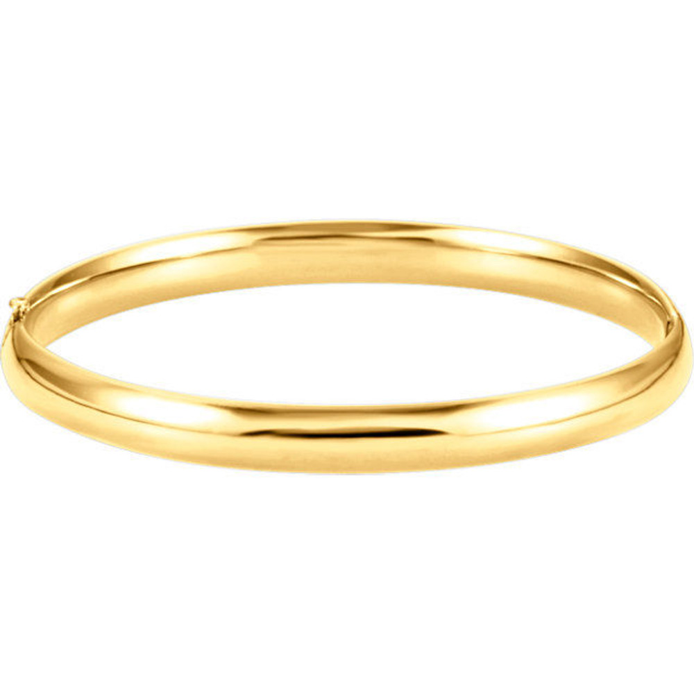 Sometimes the most beautiful things are also the most basic. This hinged style bangle bracelet made from polished 14k yellow gold is approximately 6.5mm (1/4 inch) in width by 7 inches in circumference. It has a half round hollow shape and closes with a box clasp.
