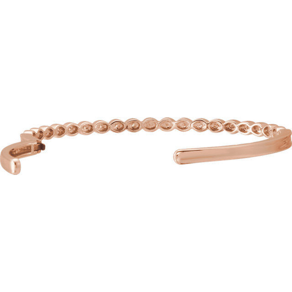 This bangle bracelet showcases round diamonds flush set in 14k rose gold. Total weight of the diamonds is 1/6cts. Total weight of the gold is 14.49 grams.