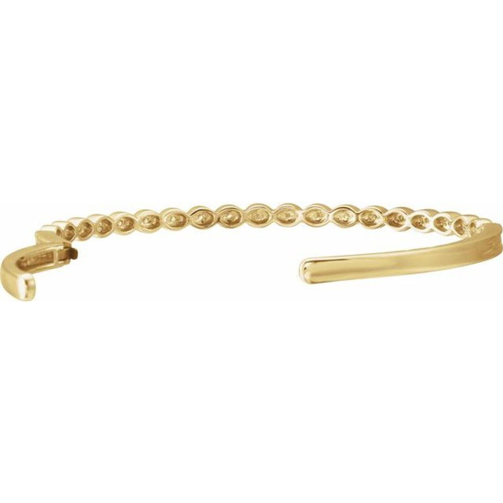 This bangle bracelet showcases round diamonds flush set in 14k yellow gold. Total weight of the diamonds is 1/6cts. Total weight of the gold is 14.49 grams.