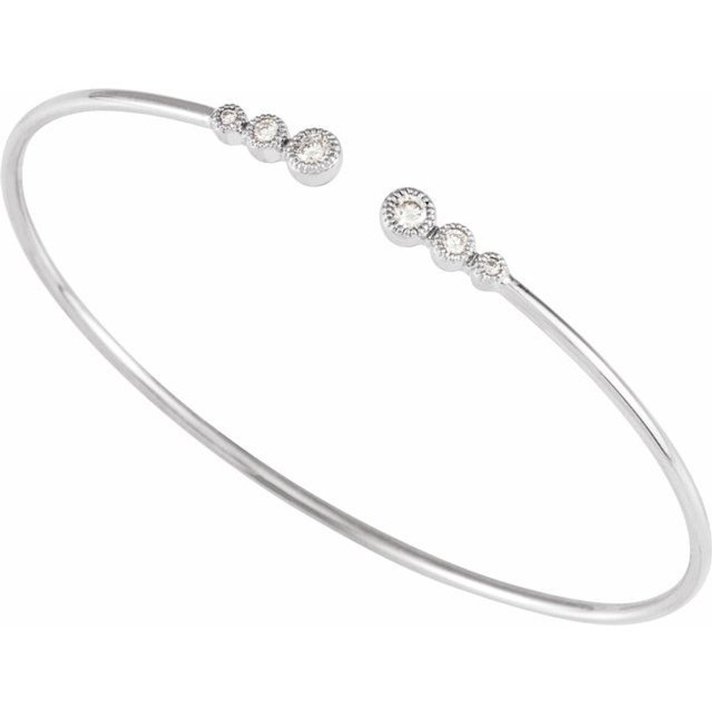 This graduated bangle bracelet showcases round diamonds set in 14k white gold.