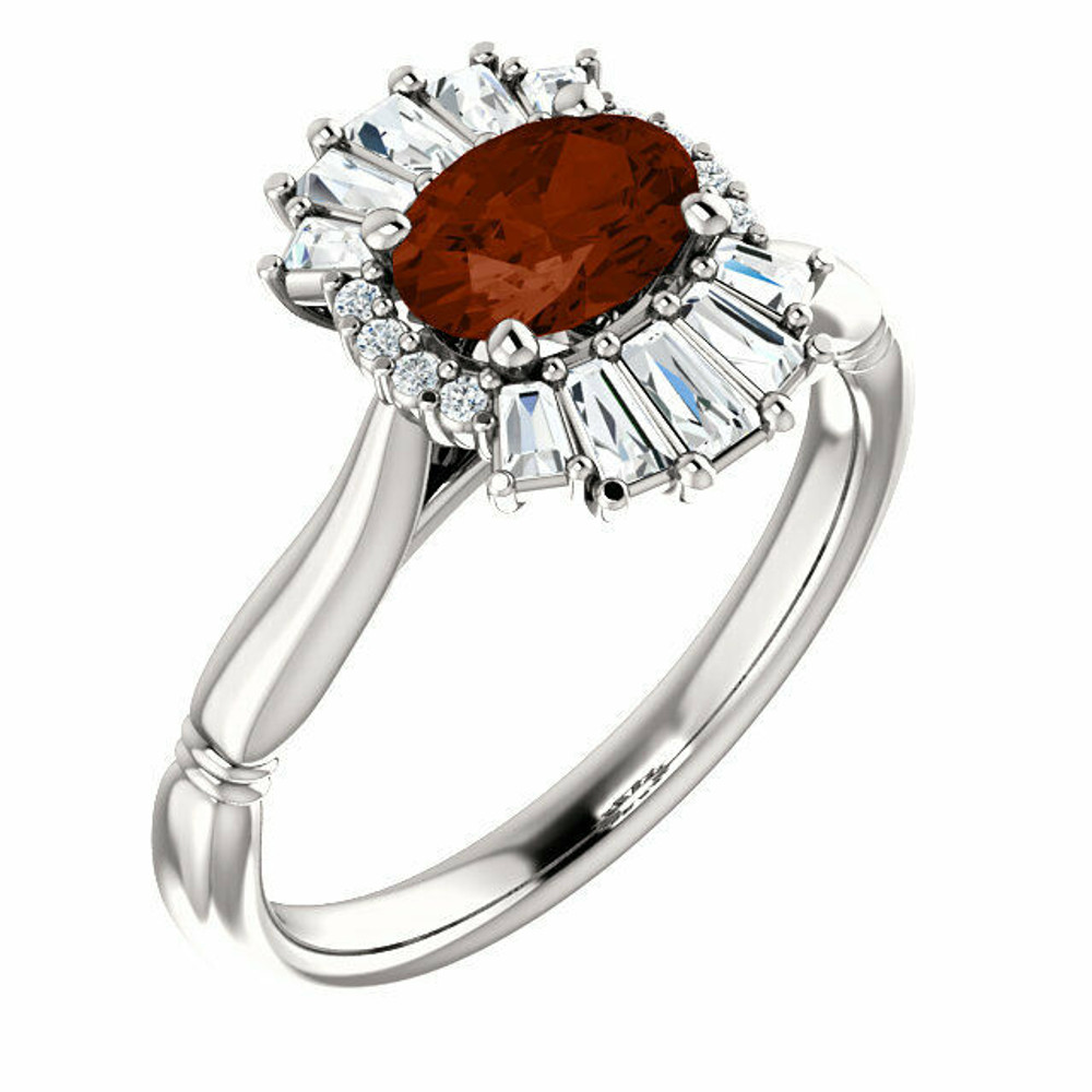 Crafted in platinum, this ring features one oval Genuine Mozambique Garnet gemstone accented with 18 genuine diamonds. 