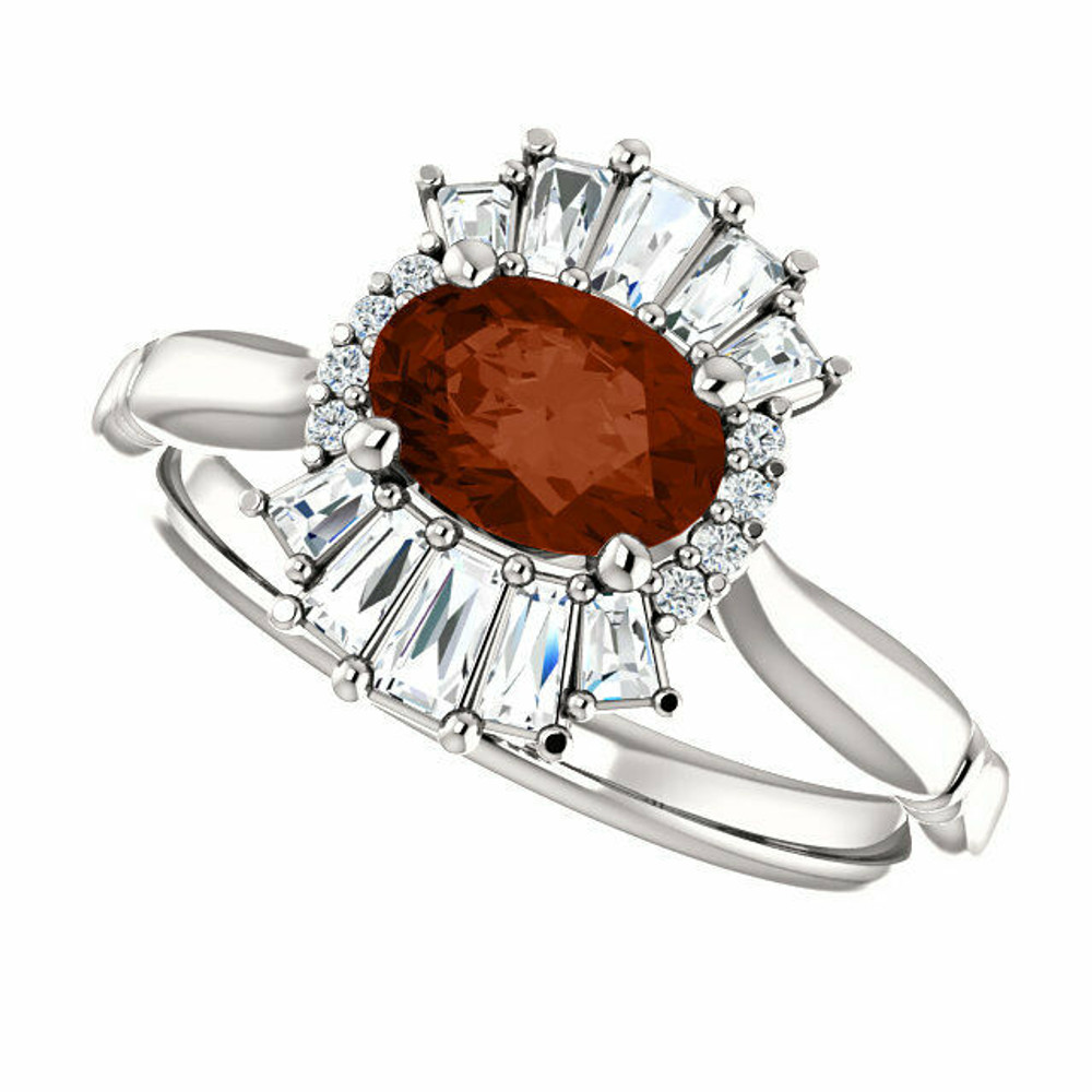 Crafted in platinum, this ring features one oval Genuine Mozambique Garnet gemstone accented with 18 genuine diamonds. 