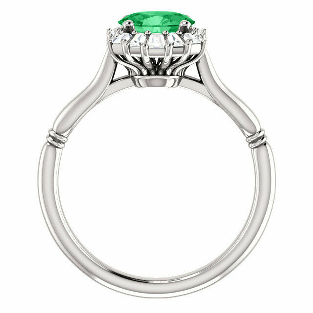 Crafted in platinum, this ring features one oval Genuine Emerald gemstone accented with 18 genuine diamonds. 