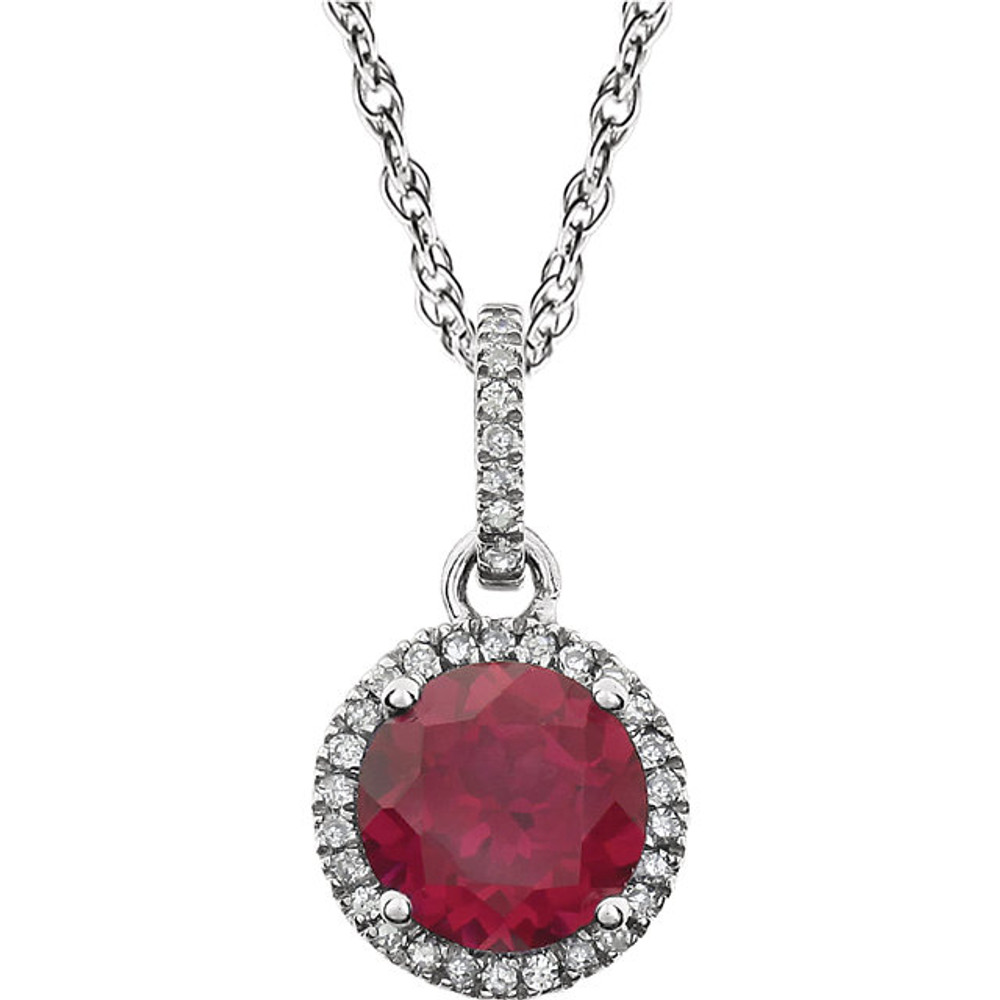 Ruby and Diamond 14k White Gold Halo-Styled 18" inch Birthstone Pendant Necklace. A 7.0mm Genuine Round Ruby is surrounded by 1/10 ct.tw. of Sparkling Genuine Round Diamonds.