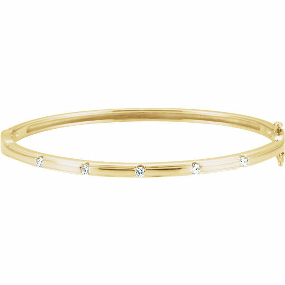 Delicately set in 14k yellow gold, this bangle has five stationed diamonds for a little touch of elegance. 