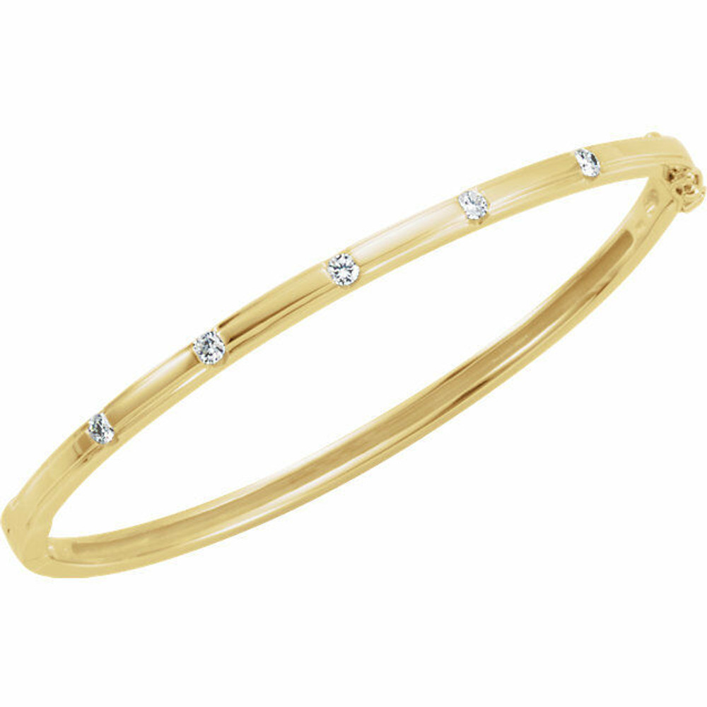 Delicately set in 14k yellow gold, this bangle has five stationed diamonds for a little touch of elegance. 