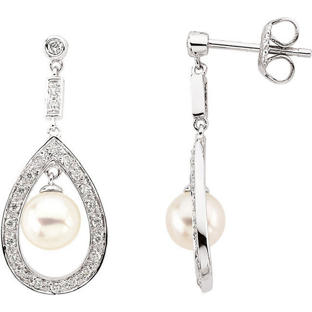 These elegant freshwater cultured pearl drop earrings sparkle with 1/4 carat total weight of round diamonds. Crafted in 14k white gold, the earrings fasten with friction backs.