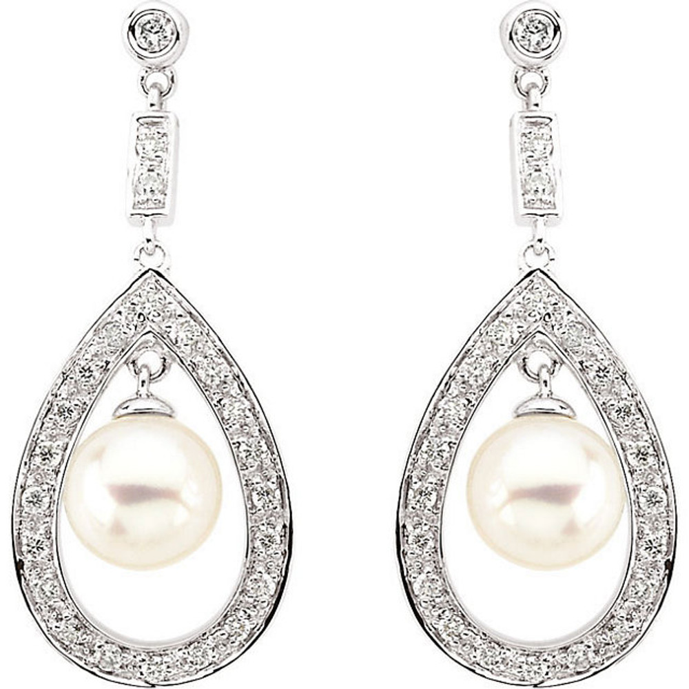 These elegant freshwater cultured pearl drop earrings sparkle with 1/4 carat total weight of round diamonds. Crafted in 14k white gold, the earrings fasten with friction backs.