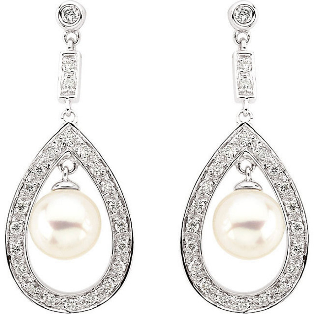 These elegant freshwater cultured pearl drop earrings sparkle with 1/4 carat total weight of round diamonds. Crafted in 14k white gold, the earrings fasten with friction backs.