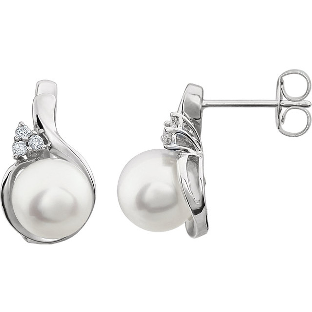 These elegant 14k white gold earrings each feature a white round freshwater pearl with diamond accents. Diamonds are .08ctw, H-J in color, and I3 or better in clarity. Earrings are 17.50mm in length and 10.20mm in width.