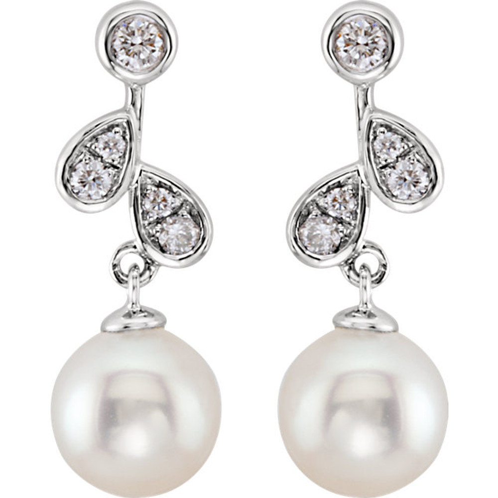 These elegant 14k white gold earrings each feature a white freshwater pearl drop with diamond accents. Diamonds are 1/6ctw, H-I in color, and I1 or better in clarity. Earrings are 18.39mm in length and 6.44mm in width.