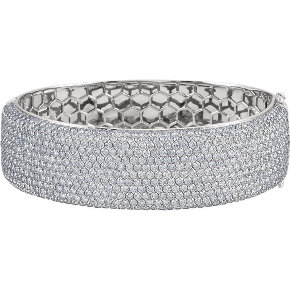 In a breathtaking presentation, this 16 1/8 ct. t.w. pave diamond bangle bracelet celebrates beauty and aesthetics with a constellation of dazzling diamond rounds. This graduated and gorgeous design is the essence of elegance. 18kt white gold bracelet. 
