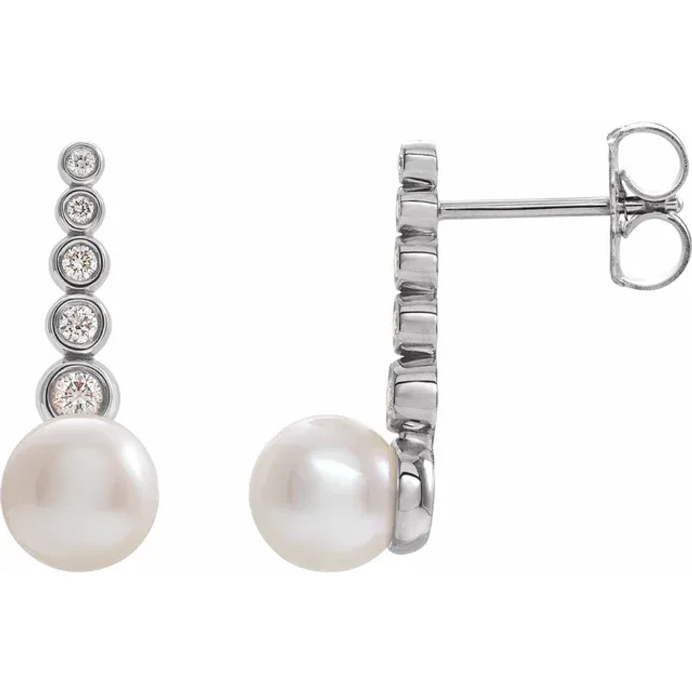These beautiful pearl earrings feature two lustrous AA+ quality 5.5-6.0mm white freshwater pearls. The pearls are mounted on sterling silver with dazzling I1 clarity diamonds. 