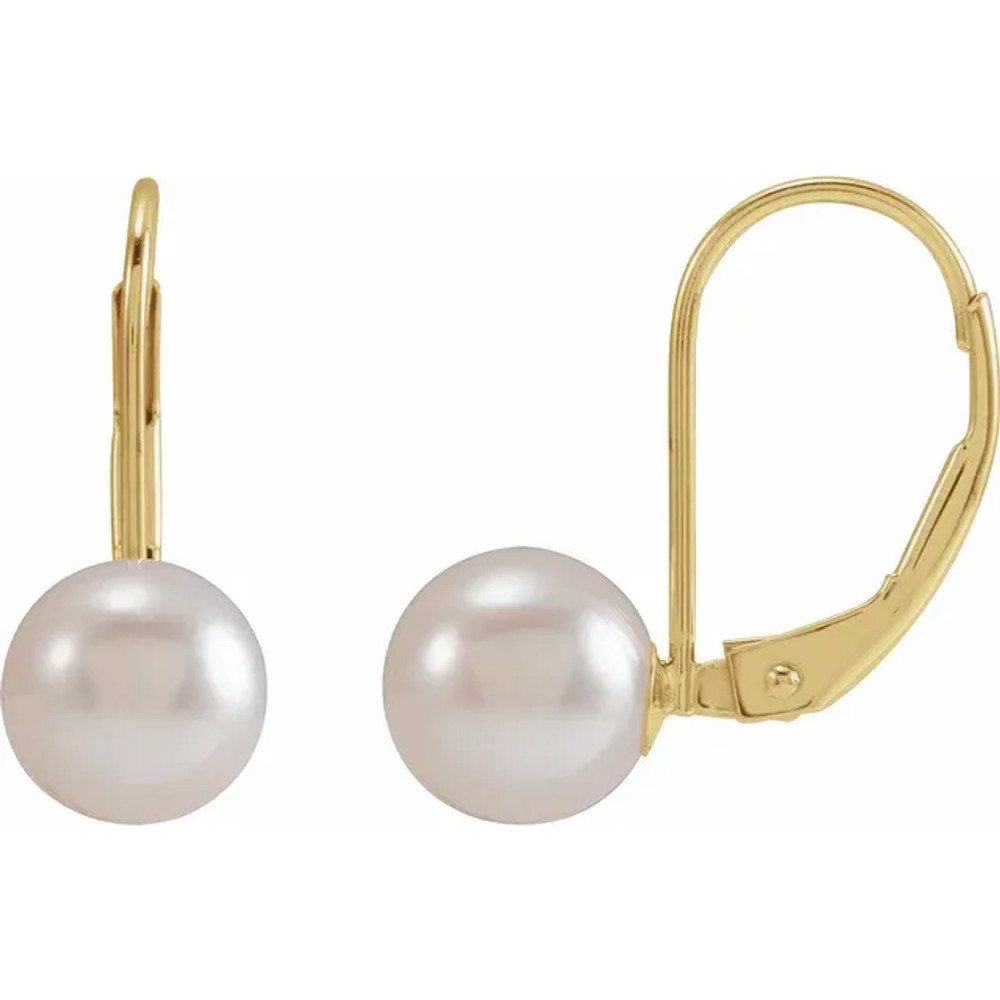 With ease and elegance, these classic pearl drop earrings complete her tailored anytime attire.