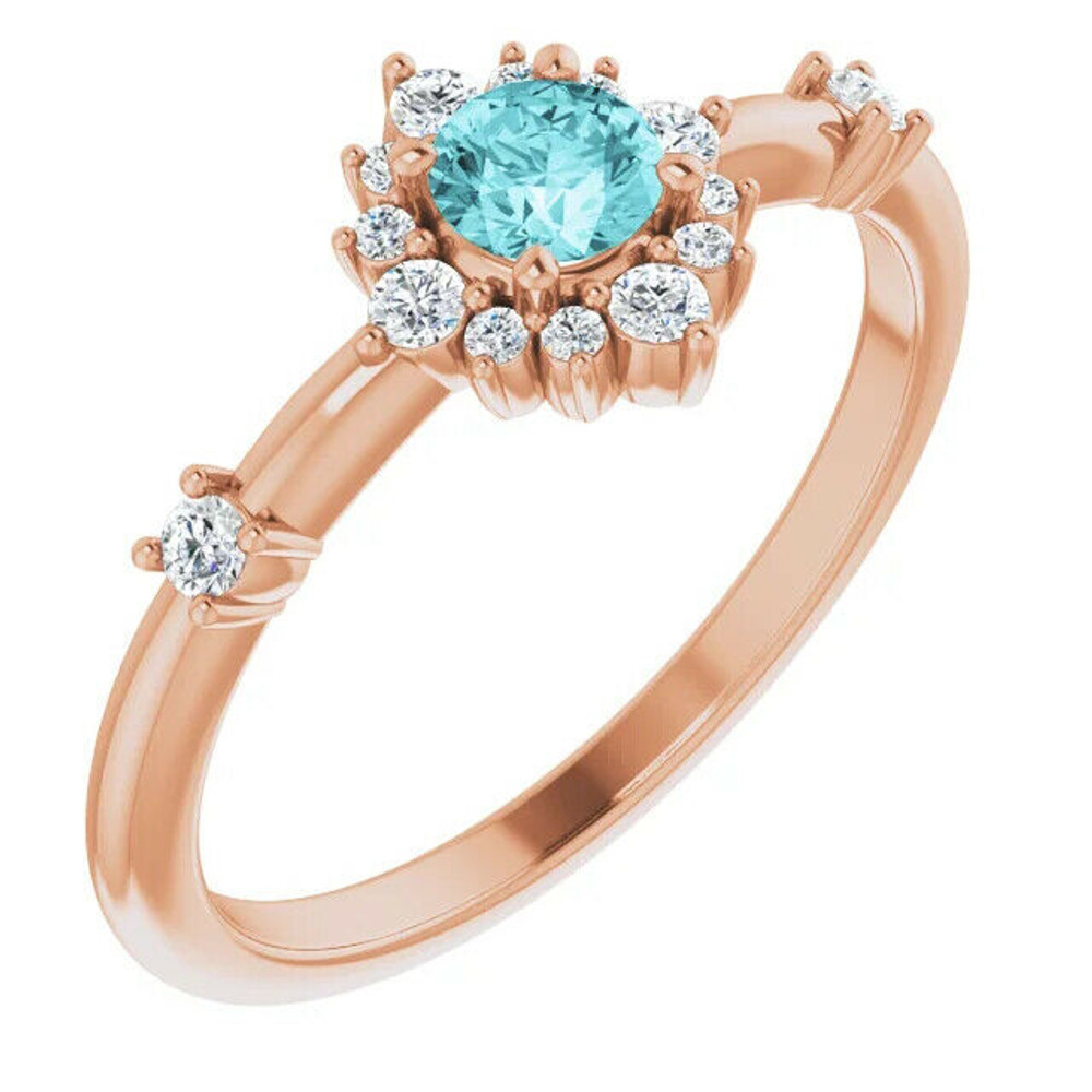 Crafted in 14k rose gold, this ring features a beautiful blue zircon and 14 round diamonds. Polished to a brilliant shine.