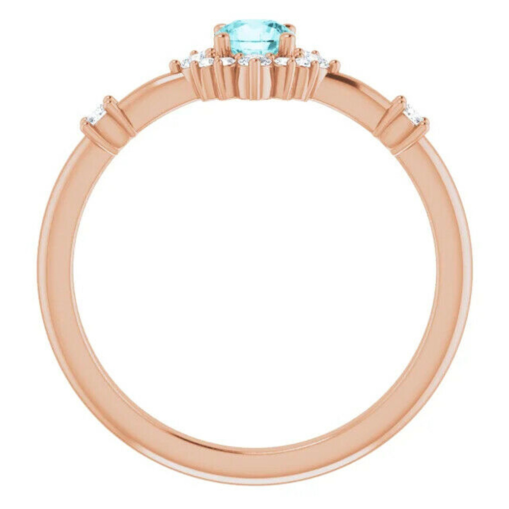 Crafted in 14k rose gold, this ring features a beautiful blue zircon and 14 round diamonds. Polished to a brilliant shine.