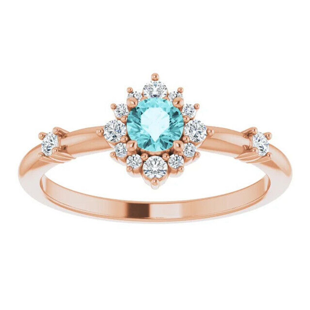 Crafted in 14k rose gold, this ring features a beautiful blue zircon and 14 round diamonds. Polished to a brilliant shine. 