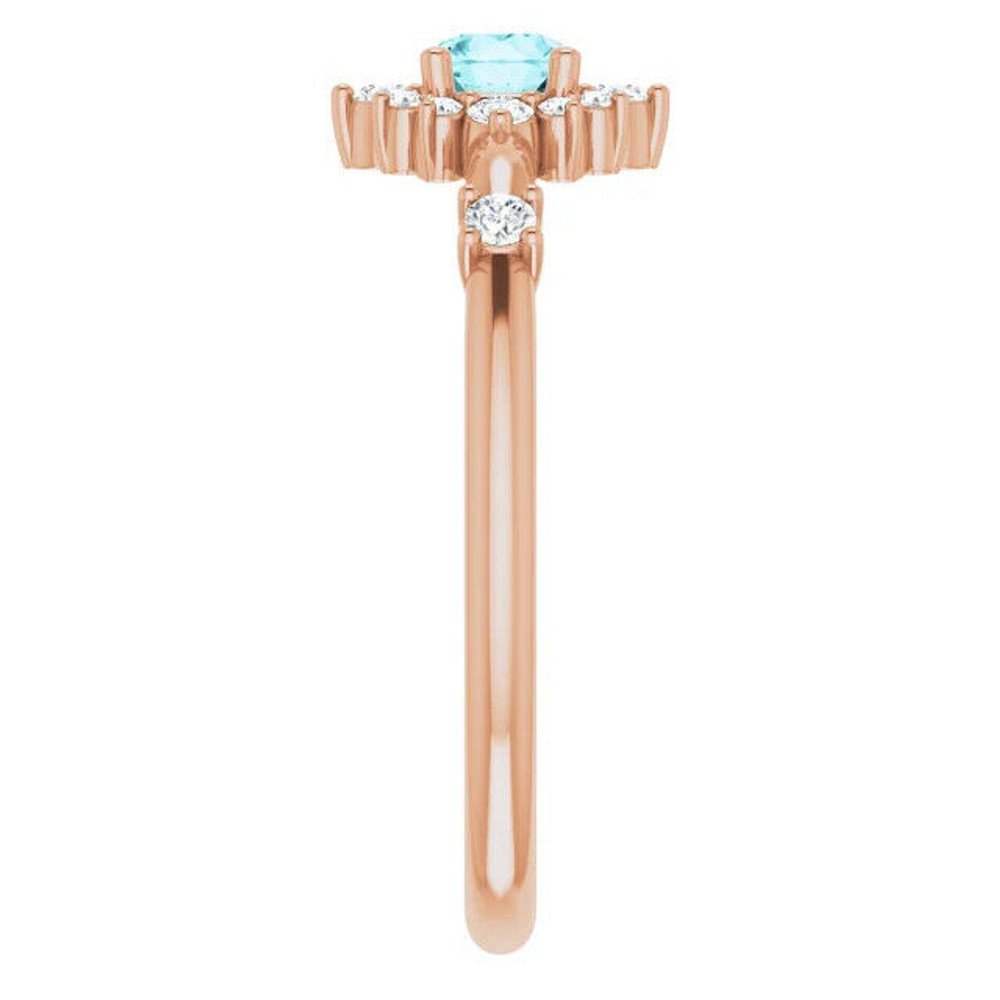 Crafted in 14k rose gold, this ring features a beautiful blue zircon and 14 round diamonds. Polished to a brilliant shine. 