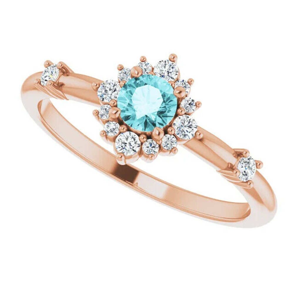 Crafted in 14k rose gold, this ring features a beautiful blue zircon and 14 round diamonds. Polished to a brilliant shine.