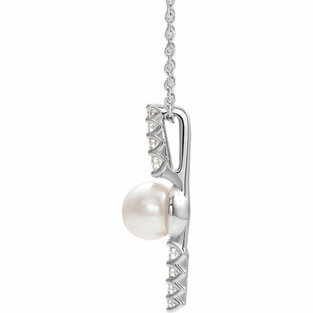 Make a bold and modern fashion statement with this cultured freshwater pearl & Diamond Pendant Necklace in sterling silver showcased by 8 sparkling accent diamonds set off by a singular freshwater cultured freshwater pearl.

Cultured freshwater pearls measure approximately 6mm to 6.5mm in diameter. Diamonds are rated I1 for clarity, G-H for color, with 1/6 total carat weight.

This distinctive pendant comes suspended on a sterling silver chain in your choice of lengths (16" or 18"), secured with a ring clasp. 