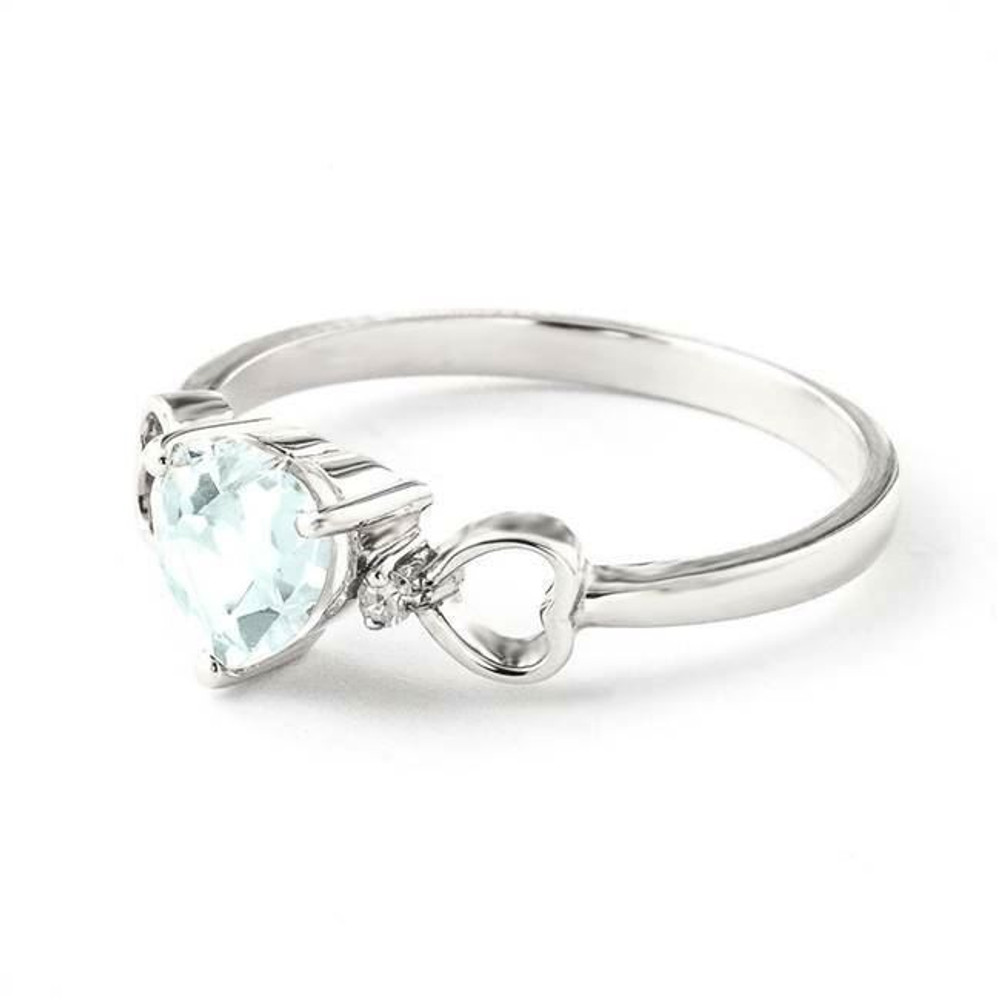 The icy blue of aquamarine will actually warm your heart in the triple-heart design of the 14-Karat white gold Ring with Diamonds and Aquamarine. The cool color of the semiprecious stone in a heart-shaped cut is a pretty addition to the decorative band it is mounted in. The heart-shaped aquamarine is set at the center and flanked by two heart shaped cut-outs on the band. A diamond accent decorates each side of the aquamarine that is at the heart of this lovely design. Celebrate a March birthday with aquamarine or simply enjoy the startling warm, loving impression that the cool-colored stone gives off through the design of the 14-Karat white gold Ring with Diamonds and Aquamarine.