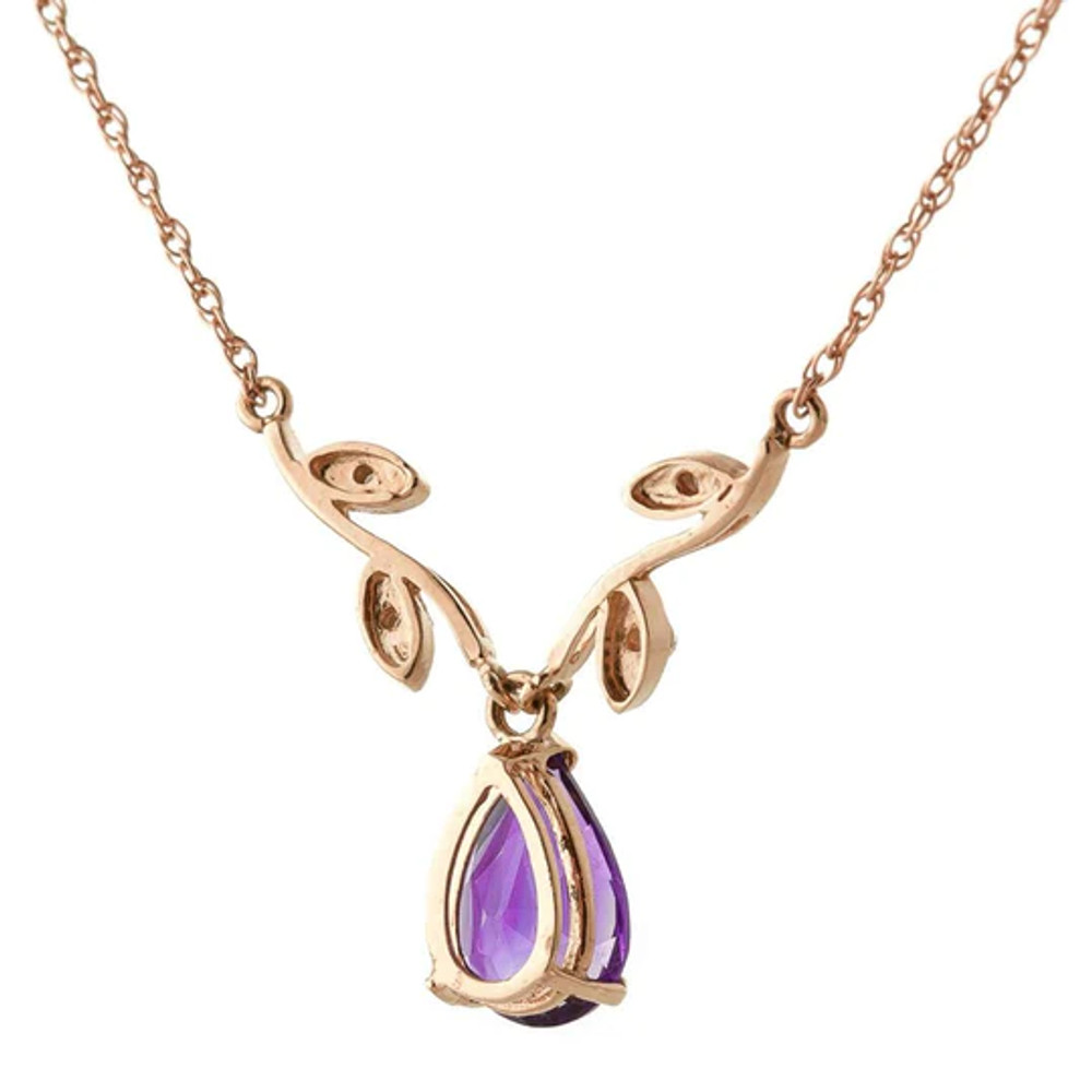 A simple solitaire style necklace is made more eye catching with the addition of stunning details on this 14k rose gold necklace with natural diamonds and purple amethysts. An 18 inch double link rope chain crafted in solid 14k yellow, white, or rose gold is used to support a gorgeous vine design.

Four leaves are featured on this design, holding four round cut natural diamonds. This shape is used to accent the dangling pear cut amethyst. The stone weighs 1.50 carats, just the right size for showing off the beauty and glimmering sparkle that this purple stone emits.