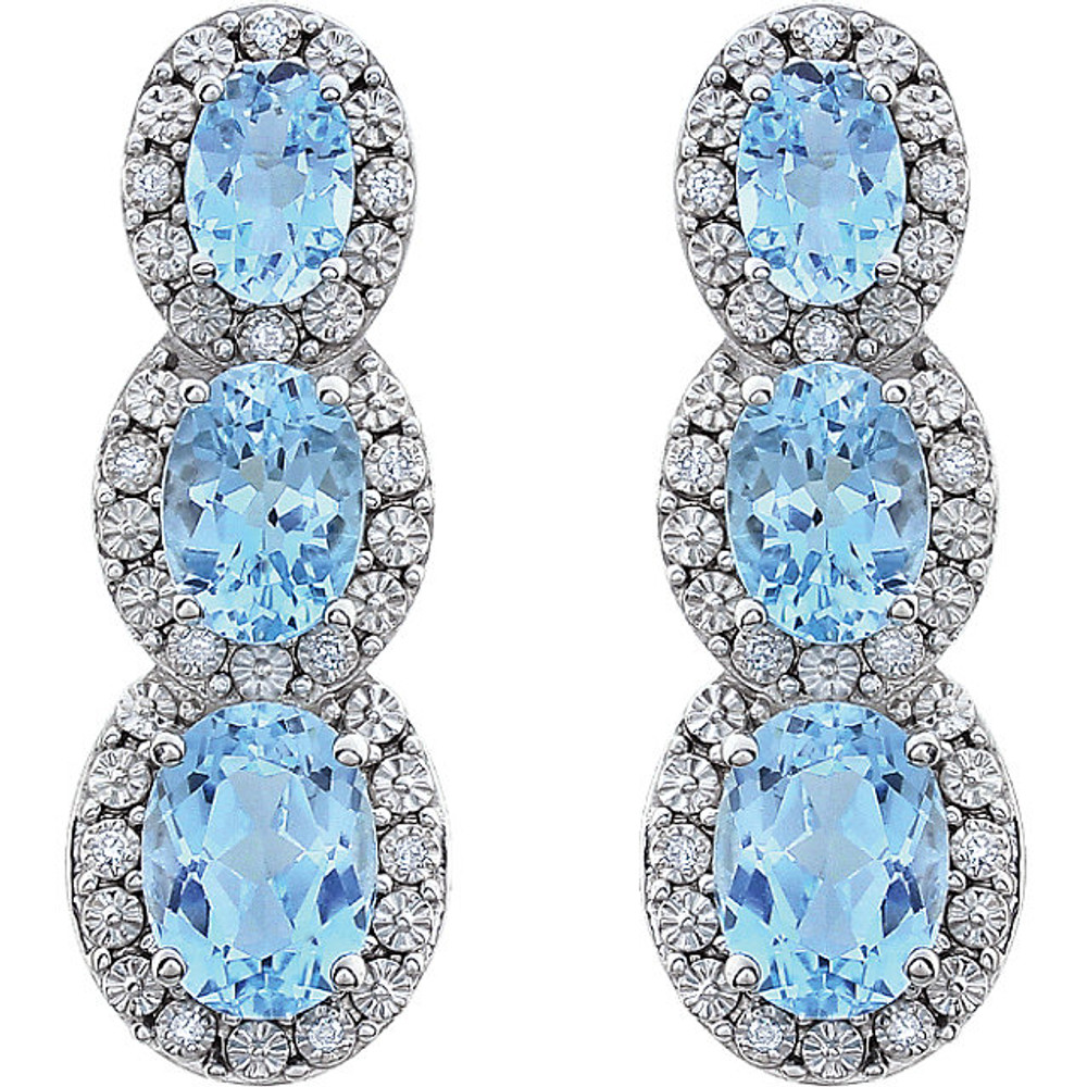 Bold and brilliant, these drop earrings are a sparkling look, perfect for that special evening out. Crafted in cool 14K white gold, each earring features three Sky Blue Topaz set one atop the other, creating a glittering linear look. Radiant with .07 cts. t.w. of diamonds and polished to a brilliant shine, these post earrings secure comfortably with friction backs.