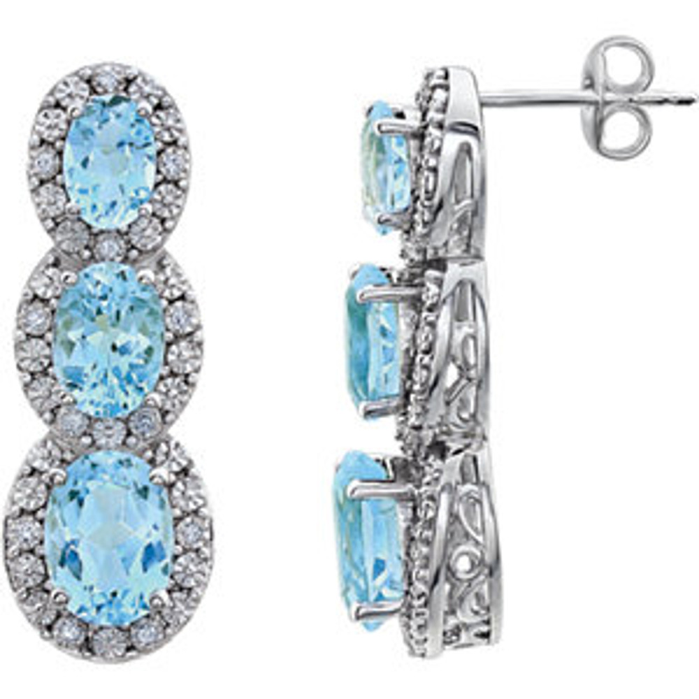 Bold and brilliant, these drop earrings are a sparkling look, perfect for that special evening out. Crafted in cool 14K white gold, each earring features three Sky Blue Topaz set one atop the other, creating a glittering linear look. Radiant with .07 cts. t.w. of diamonds and polished to a brilliant shine, these post earrings secure comfortably with friction backs.