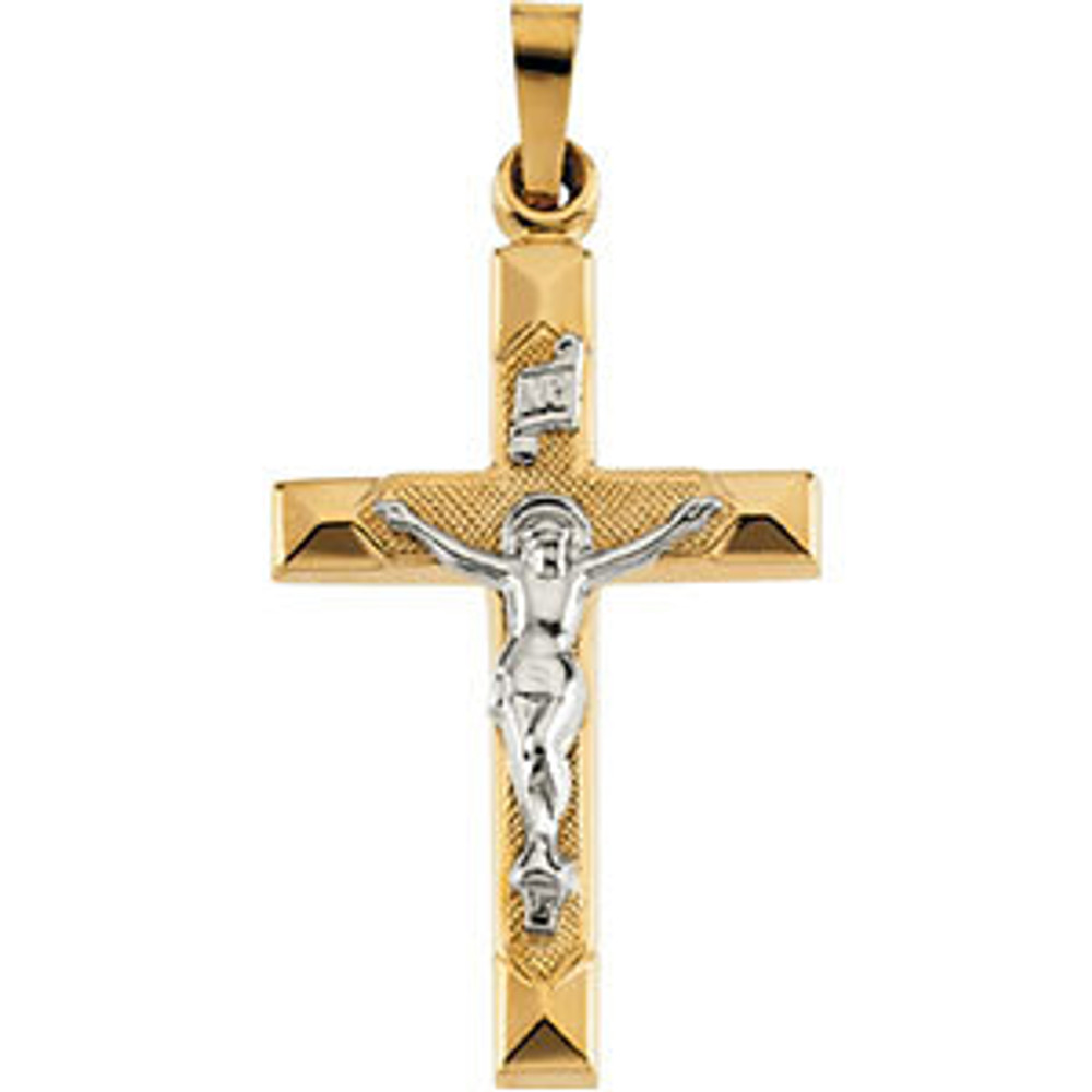 Delicate in design, this hollow crucifix pendant is crafted in 14k yellow/white gold and measures 25.00x17.00mm. Chain sold separately!