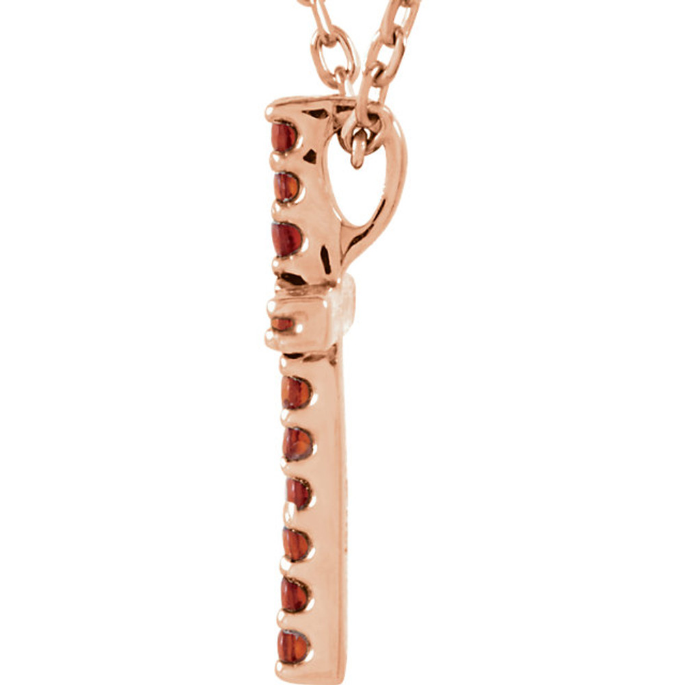 Artistry and faith merge to create this striking 14k rose gold gemstone cross pendant made of Genuine Garnet Mozambique stones in a prong setting with a 16" diamond cut cable chain.