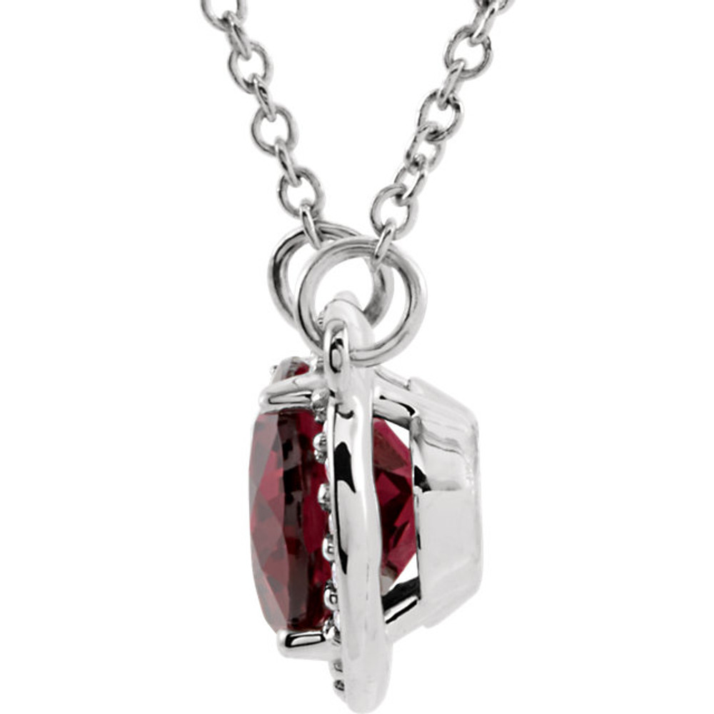 This 14k white gold pendant is perfect for everyday wear! The pendant features a oval 09.00x07.00mm garnet gemstone surrounded by 20 round cut diamonds. An 16 inch solid cable chain is included.