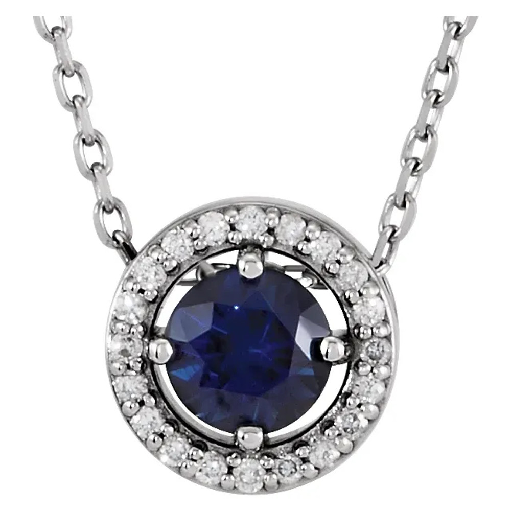 This gorgeous gemstone and diamond necklace features a 4.50mm round shaped Blue Sapphire that is surrounded by brilliant cut round diamonds in a halo fashion. You'll love wearing it again and again.