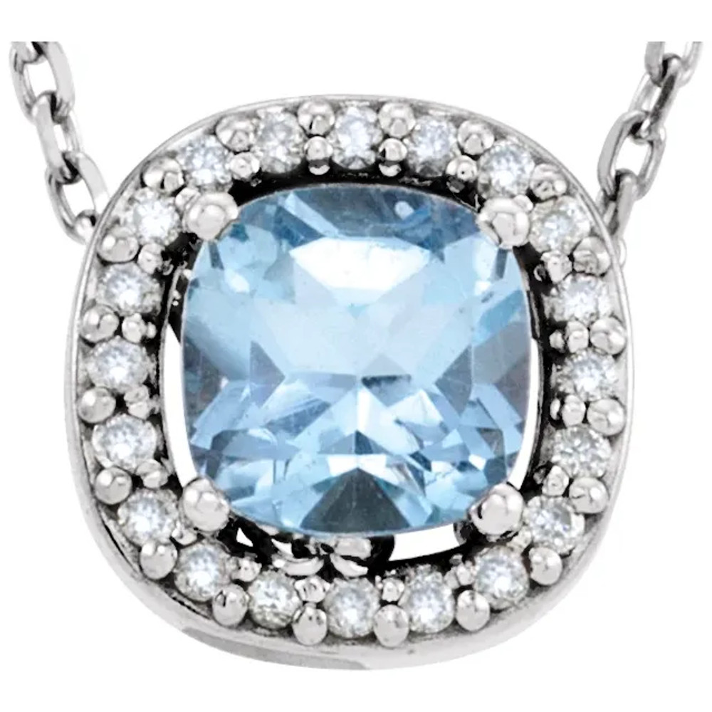 This gorgeous gemstone and diamond pendant features a 5x5mm oval shaped blue topaz that is surrounded by brilliant cut round diamonds in a halo style. You'll love wearing it again and again.