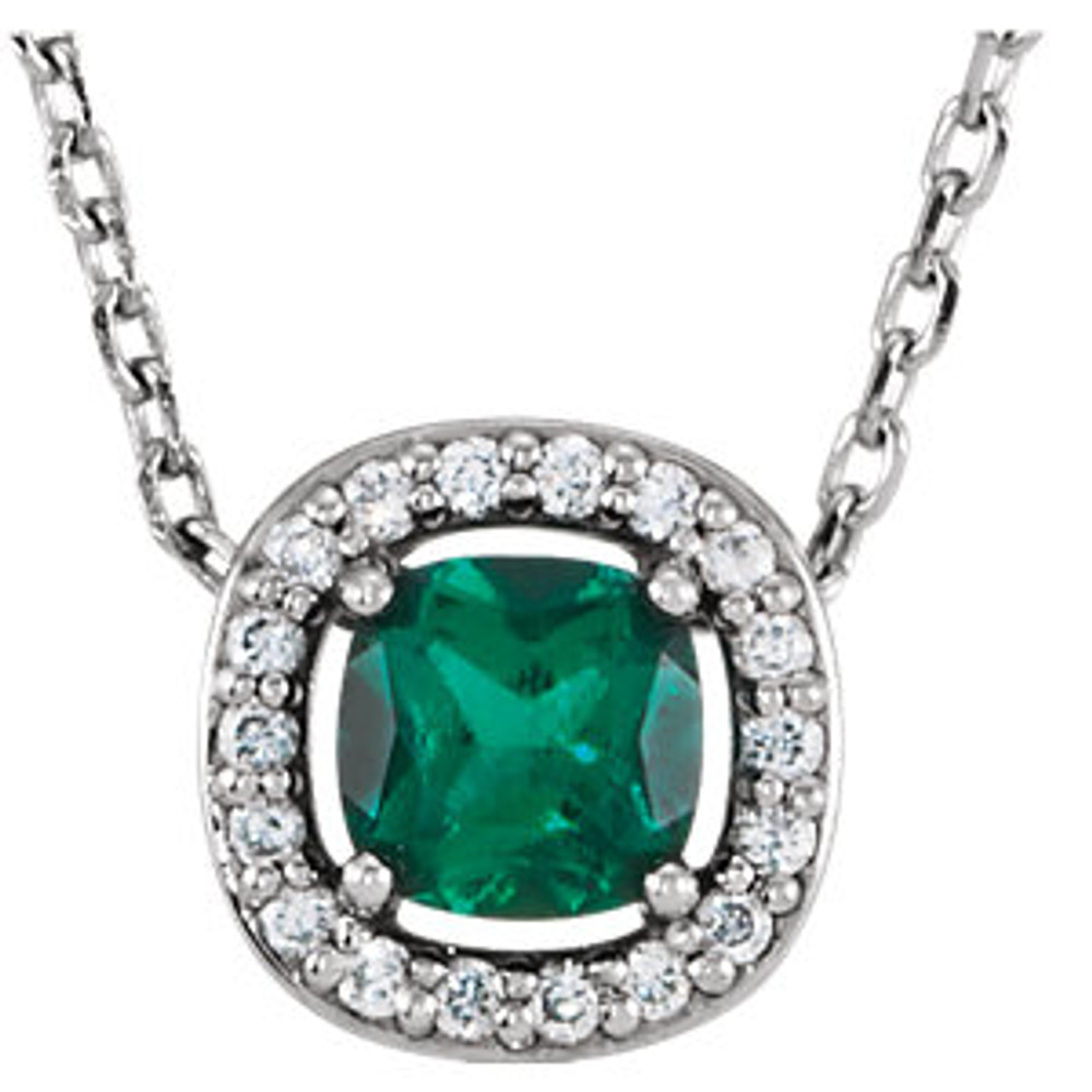 Round diamonds accent each side of a lab-created emerald in this halo-style necklace for her.